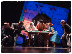 Cast surround a map of a house reminiscent of a board game