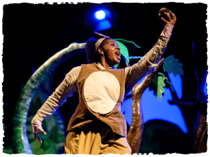 a performer holding a fruit up in the air