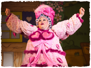 Dame Mary cheering in a pink dress