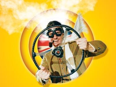 Man holds wheel of car with goggles on