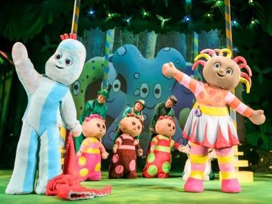 Performers dressed as In The Night Garden Characters Igglepiggle and Upsy Daisy wave on stage
