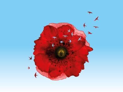 A poppy on a blue background with a soldier etched into the seed